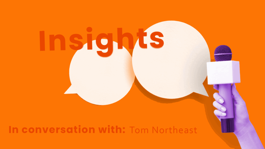 A hand holds a microphone in front of two speech bubbles on an orange background, featuring the words “Insights” and “In conversation with: Tom Northeast, UX Designer at Zahara.”.